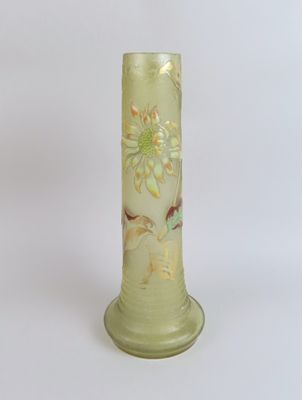 a green vase with flowers on it on a white background