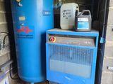 a blue water heater and a blue tank in a garage