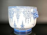 a blue and white bowl sitting on a black table