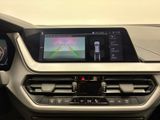 the interior of a car with a touch screen and a steering wheel