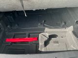 a red pipe sticking out of the trunk of a car