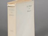 an old book sitting on top of a table next to a gray surface