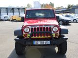 a red and black jeep parked in a parking lot