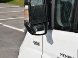 mirrors on the side of a white truck in a parking lot