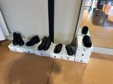 several pairs of shoes are lined up on a shelf in front of a mirror