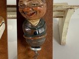two wooden figurines of a man and a woman on a bench