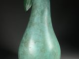 sculpture of a green pear with a leaf on top of it