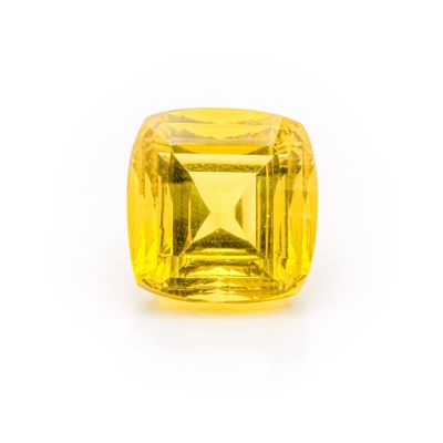 a yellow sapphire stone on a white background