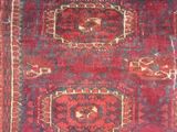 an old rug with a red and blue design on it