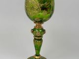 green glass goblet with gold leaf decoration on base