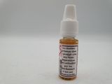 a close up of a bottle of liquid on a white surface