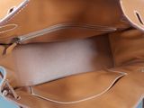 a purse that is sitting on a blue surface
