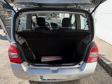 the back of a silver car with its trunk open in a parking lot