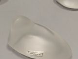 a white mouse sitting on top of a white table