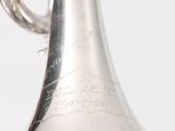 a silver vase with a silver handle on a table