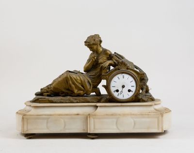 a statue of a woman with a clock on top of a table