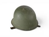 an old military helmet on a white surface with a white background