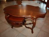 a wooden table with a drawer underneath it on a tile floor