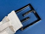 a white belt with a black buckle on a blue surface