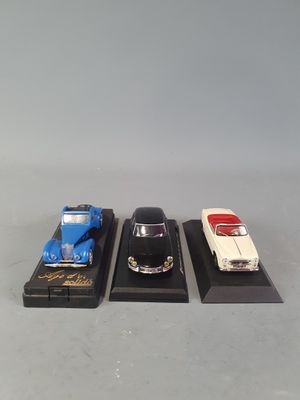 three toy cars on display on a table