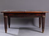 an old wooden table with a marble top and legs