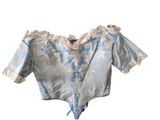 an image of a blue and white blouse on a white background