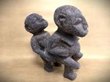 a statue of a man holding a baby on his lap