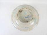 a white bowl with a blue and brown design on it