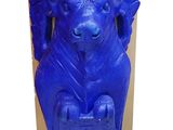 a blue statue of an elephant sitting on a box