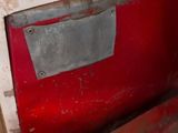 a close up of a red and white car door