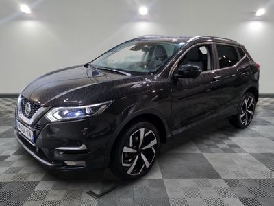 a black nissan suv parked on a checkered floor in a garage