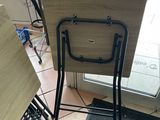 a folding table and chair in the corner of a room
