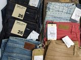 several pairs of men ' s jeans are on display in a store