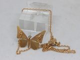 a small box with a butterfly on it and a chain attached to it