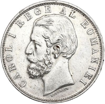 Gros plan sur une pièce de monnaie portant le visage d'un homme