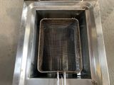 an image of a fryer with a basket inside of it