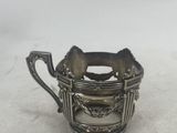 an antique silver plated teapot with a handle on a white surface