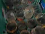 a green container filled with empty glassware on a counter