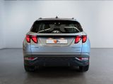 the rear end of a silver suv parked in a showroom