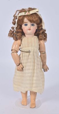 a small doll that is standing on a white surface
