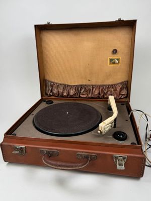 a brown suitcase with a record player inside of it