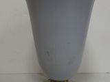 a white vase with a gold rim sitting on a table