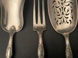 three spoons and a fork sitting on a table