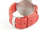 wrist watch with red leather strap on white background on white surface