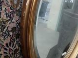 a mirror that is sitting on the wall next to a rug
