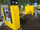 a yellow machine that is sitting on the side of the road