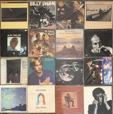 a lot of records on the wall of a room