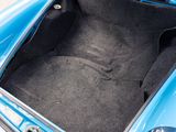a blue car with its trunk open in a parking lot