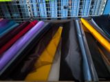 many different colors of fabric in a wire basket