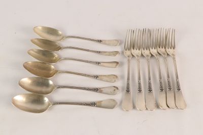 a lot of silver spoons and forks on the table